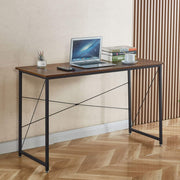 Minimalist teak wood computer desk used as a home office workstation
