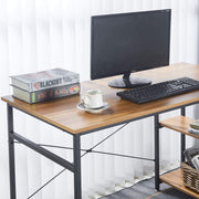 modern teak computer desk with computer monitor, keyboard, books, and coffee cup on spacious wood surface