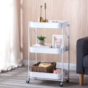3-Tier Storage Cart in white with three baskets, decorative items, and plants, perfect for organizing and maximizing space.