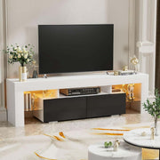 White and black TV unit with warm LED shelves beneath a large television