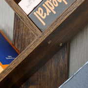 Close-up view of the Freestanding Tree Bookshelf with Cabinet showcasing books and details of the wood structure.