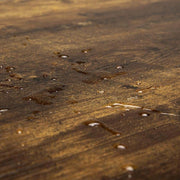 Close-up of a textured wooden surface with visible grain and imperfections.| Artisansa SA