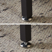 Close-up of the adjustable feet of the 3-Compartment Laundry Sorter on a carpeted surface.