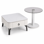 White side table with a drawer and a round glass top table on a white background