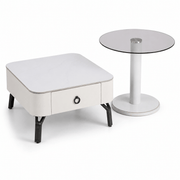 White side table with a drawer and a round glass top table on a white background