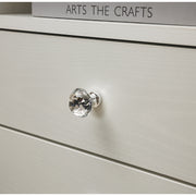 Close-up of a crystal knob on a White Bedside Table with Drawers, showcasing elegant design details.