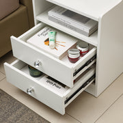 White Bedside Table with Drawers showcasing open drawers with cosmetics and books.