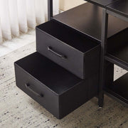 Close-up of black storage drawers in a TV stand with charging station, showcasing smart storage solutions for a neat living room.