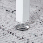 Adjustable leveling foot pad on white computer desk metal leg for stability