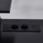 Close-up of black built-in AC power outlets and USB ports