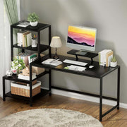 Black home office computer desk with monitor stand and storage shelves in living room
