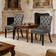 Dining Chairs Set of 2 tufted velvet chairs with button-back design and nailhead trim in elegant interior setting.