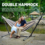 Double Hammock with Steel Stand set up in a lush yard, featuring a couple enjoying relaxation in vibrant stripes.