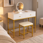 White dressing table with round mirror and stool beside a bed