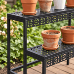 Close-up of decorative perforated metal shelves and flower pots on the plant stand