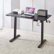 Electric Standing Desk Black Adjustable 120cm with laptop and speaker on top, ideal for ergonomic workspaces.