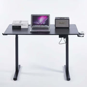 Electric Standing Desk black adjustable with laptop, books, and speaker, designed for ergonomic comfort.