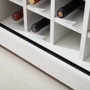 Interior view of Farmhouse Wine Bar Cabinet showcasing wine bottle storage with a rustic white finish.