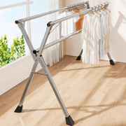 Foldable Clothes Rail with stainless steel X-frame holding various garments in a well-lit room.