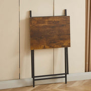 Rustic folding TV tray table standing against a wall, designed for easy storage and portability.