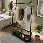 Freestanding Clothes Rack with hanging clothes, open bottom shelf, and lockable wheels in a stylish bedroom.