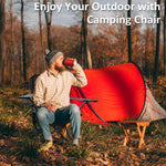 Man enjoying a drink while seated in a Heavy-Duty Folding Camping Chair at a campsite.