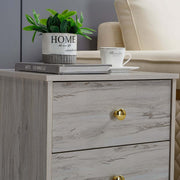 Modern 3-Drawer Nightstand with gold handles and decorative elements on top.