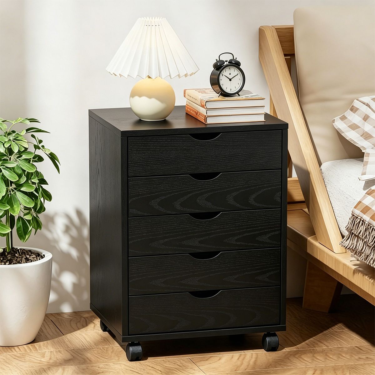 Black Bedside Table with Drawers (5-Tier) next to a lamp and clock, providing stylish storage solutions.