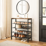 Industrial shoe rack beneath a round entryway mirror with shoes on mesh shelves and decorations on top
