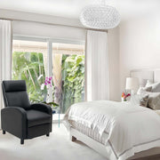 Stylish manual recliner chair in modern bedroom with white decor and tropical view.