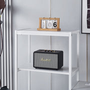 White computer desk shelving unit displaying smart speaker and decor