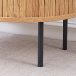 Sturdy black metal legs on round side table with storage