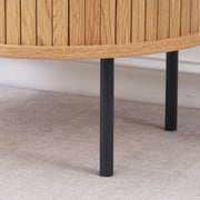 Sturdy black metal legs on round side table with storage