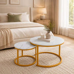 White and gold round nesting coffee tables styled in a warm modern bedroom lounge
