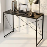Black folding computer desk styled as a compact home office workstation