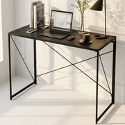 Black folding computer desk styled as a compact home office workstation