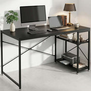 Black computer desk with reversible shelves styled as a modern home office workstation