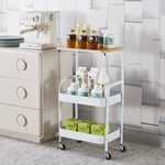 3-Tier Rolling Storage Cart with Wood Top displaying various bottles and jars on a stylish kitchen countertop.