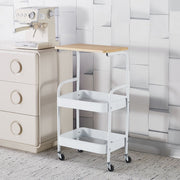 3-Tier Rolling Storage Cart with Wood Top placed next to a coffee machine and a beige dresser.