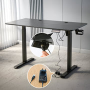 Electric Standing Desk in black, showcasing adjustable height mechanism and power connections for ergonomic work setup.