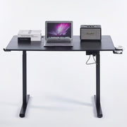 Electric Standing Desk black adjustable with laptop, books, and speaker, designed for ergonomic comfort.