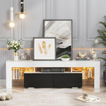 White and black TV unit styled with artwork and warm LED lighting in a bright lounge