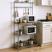 Heavy-Duty Baker's Rack featuring a wood top and organized kitchen appliances including pots and microwaves.