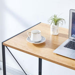 Close-up of Grey Wood desktop surface with laptop, cup and plant
