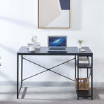Front view of black computer desk with laptop and reversible two-tier shelving