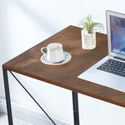 Close-up of Burningwood desktop surface and edge with laptop, cup and plant