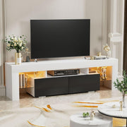White and black TV unit with warm LED shelves beneath a large television