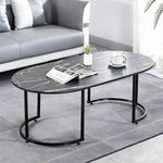Oval Black Marble Coffee Table with modern design, showcasing a sleek surface and black metal legs in a contemporary living space.