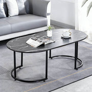 Oval Black Marble Coffee Table with modern design, showcasing a sleek surface and black metal legs in a contemporary living space.