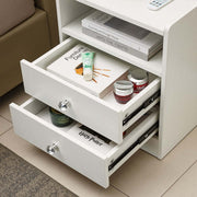 Modern LED Bedside Table with drawers showcasing books and beauty products for stylish organization.